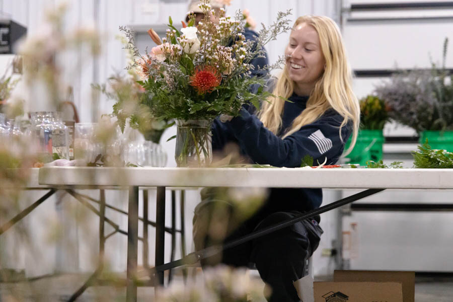 horticulturist creating a floral arrangement