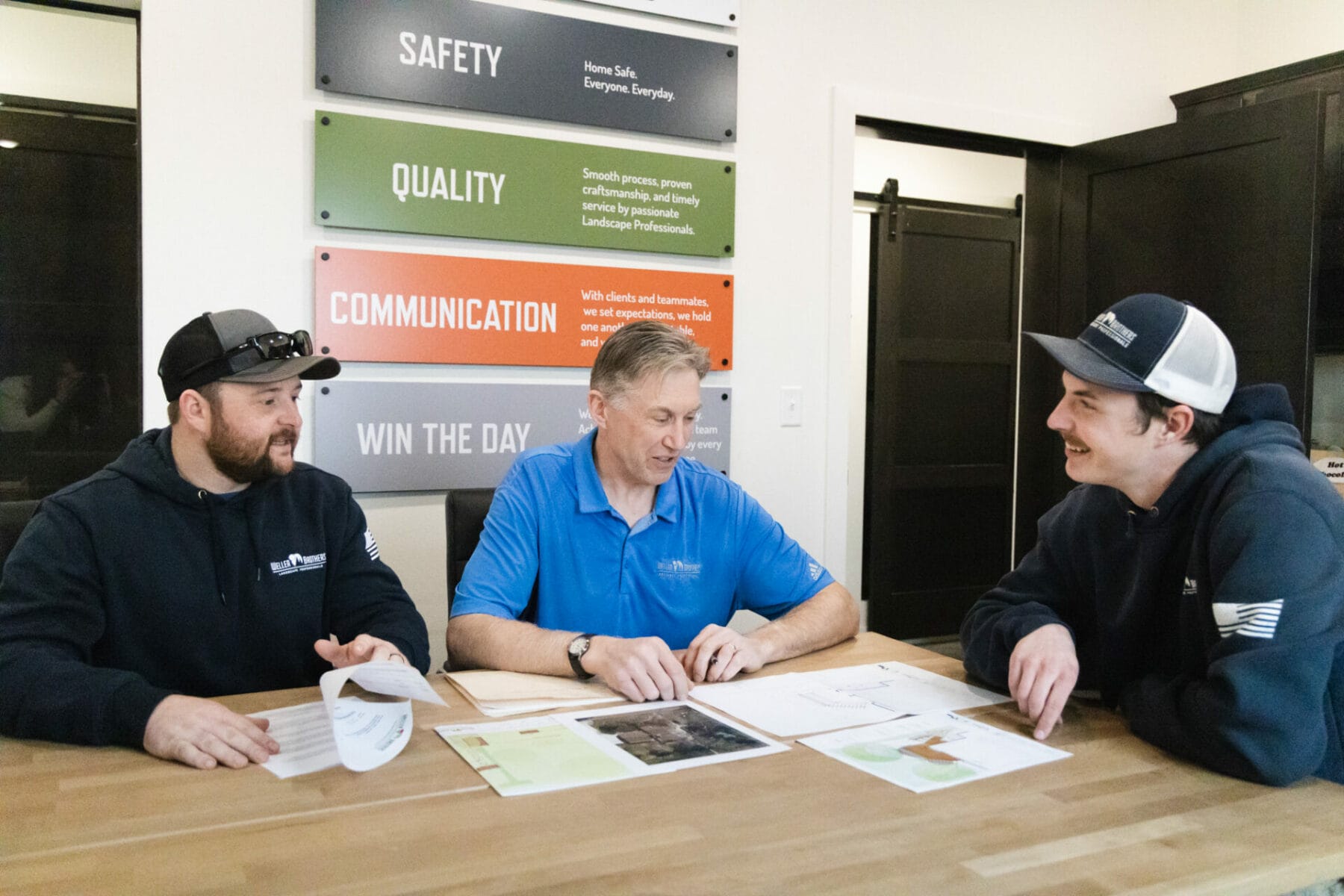 Weller Brothers employees discussing a design at a table