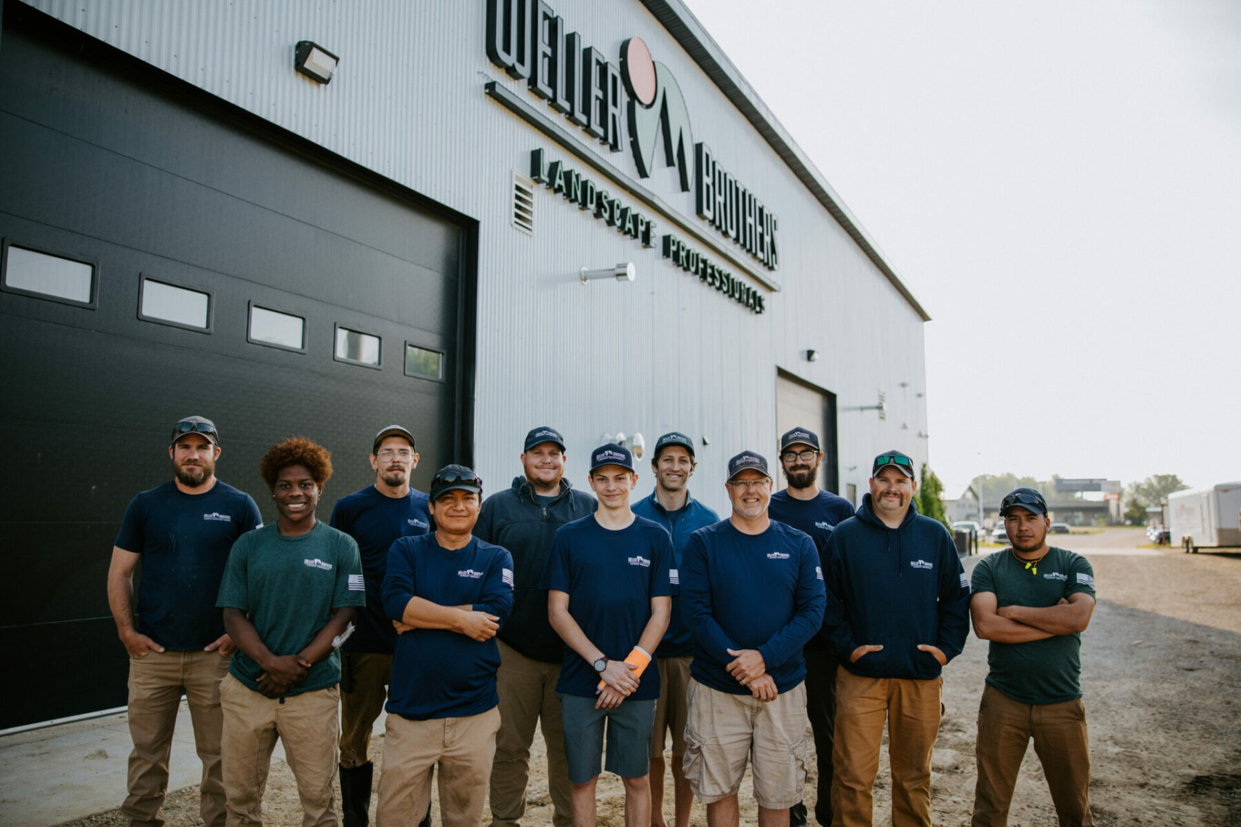 Rochester, MN lawncare team in front of Weller Brothers building