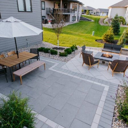 outdoor dining set and firepit seating on a backyard patio