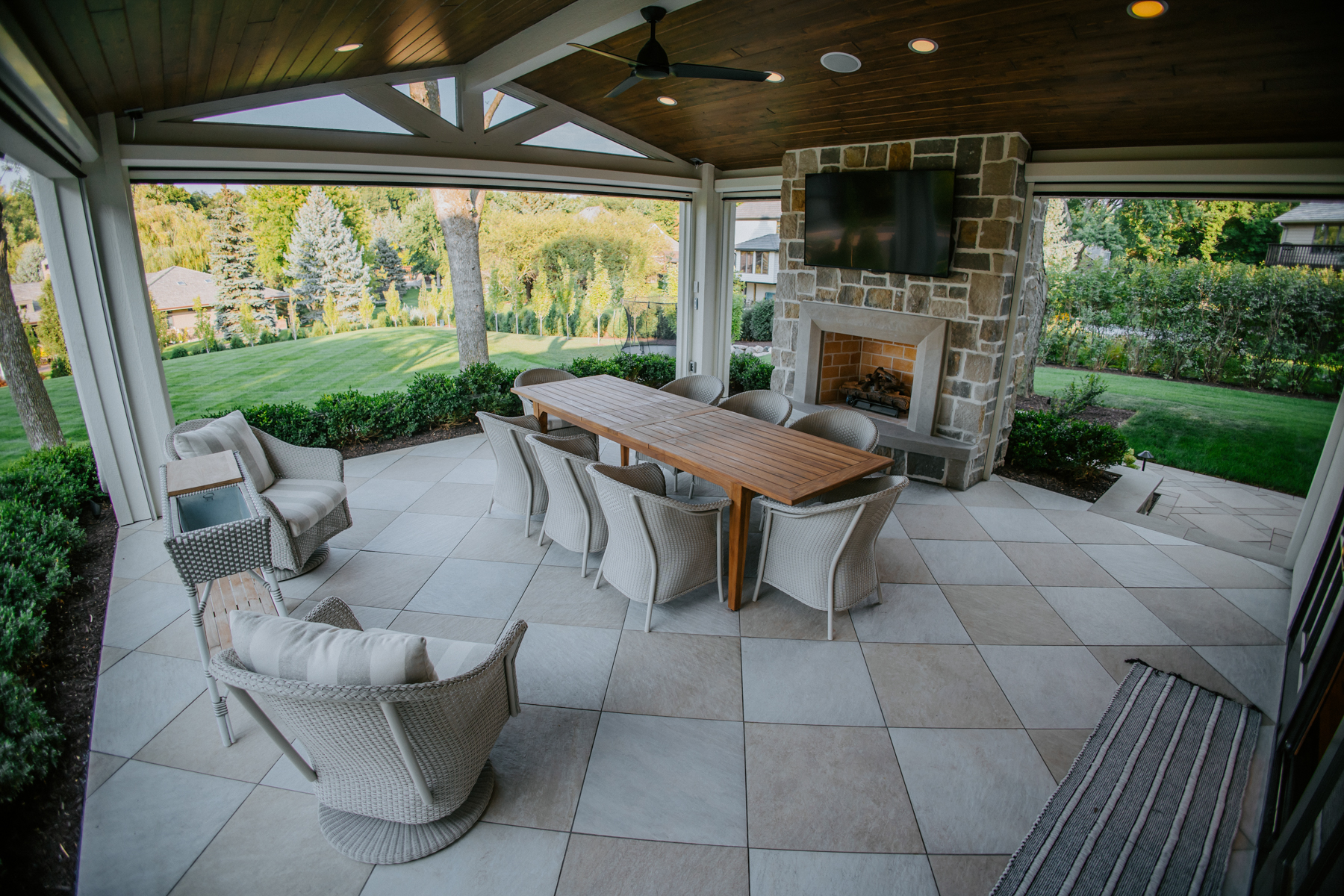 outdoor dining area in three-season porch with fireplace