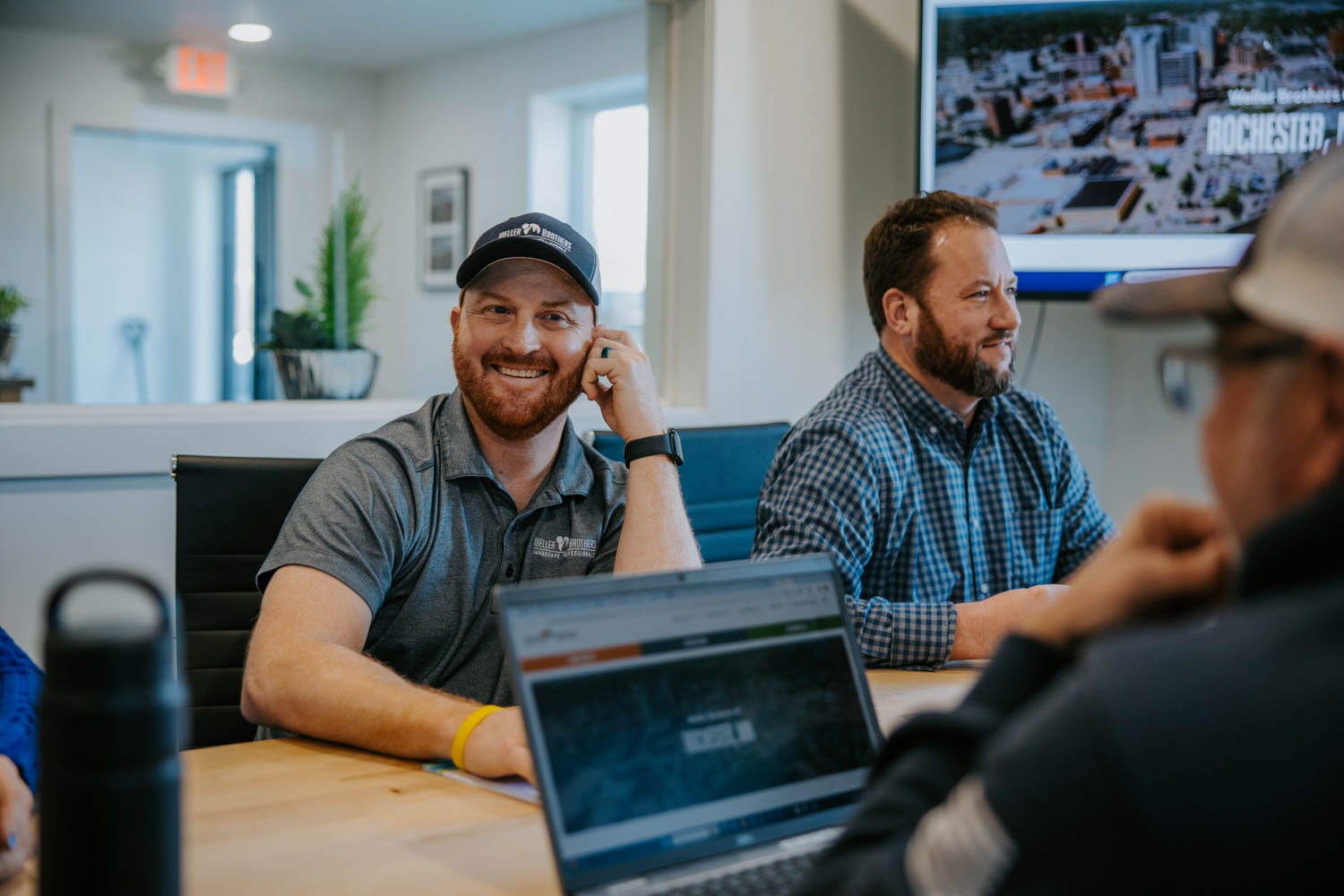 Kirk Olson laughs during a team meeting at a Rochester, MN, landscaping company