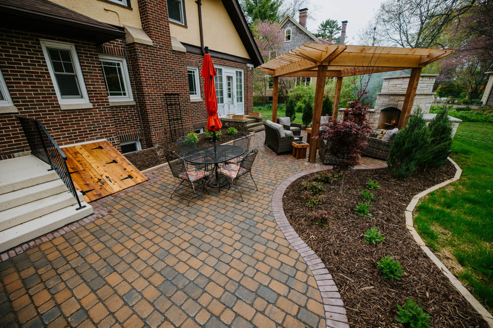 Ames, IA, backyard landscaping with patio, pergola, and fireplace