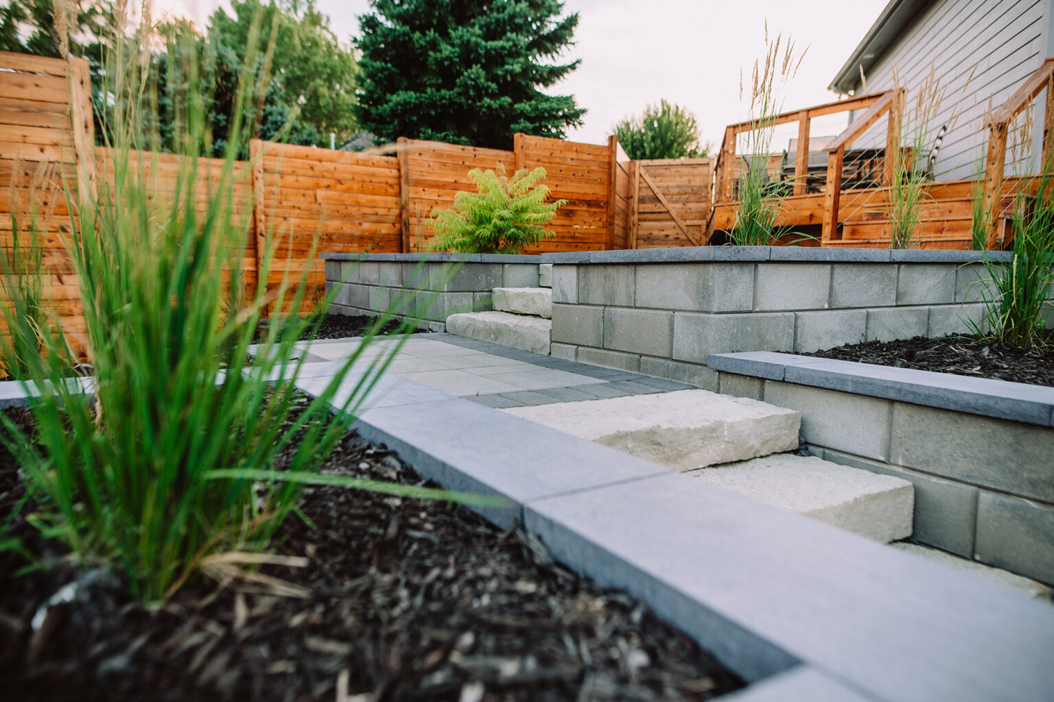 flower bed and backyard staircase by Weller Brothers Landscaping
