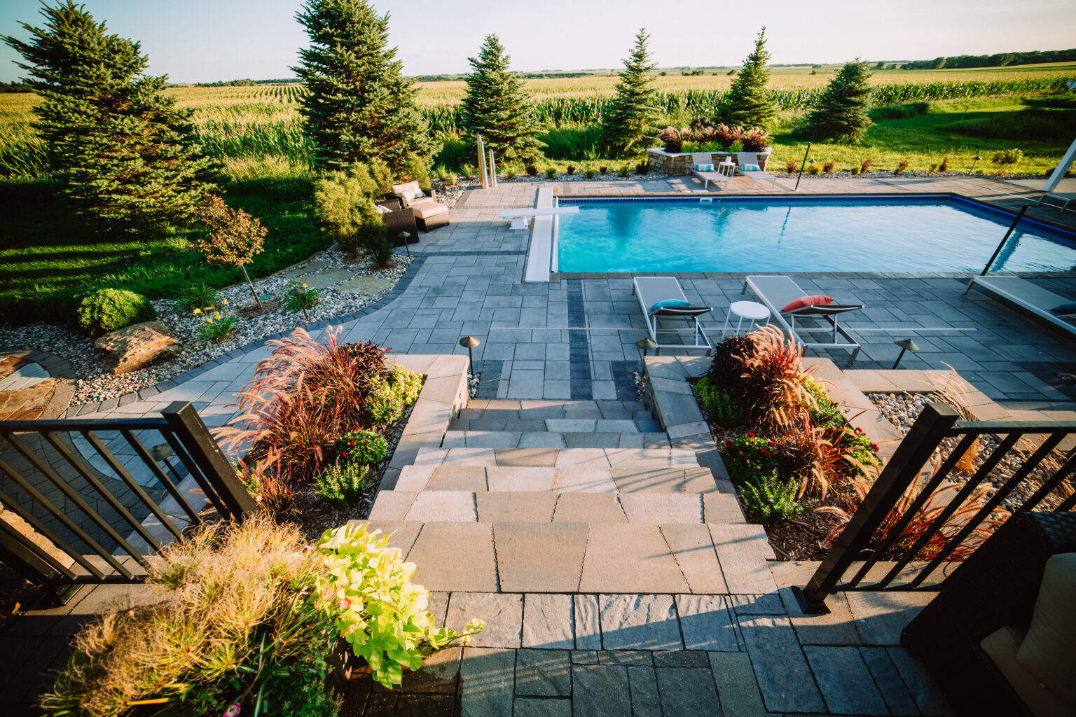 raised patio with concrete pavers and pool
