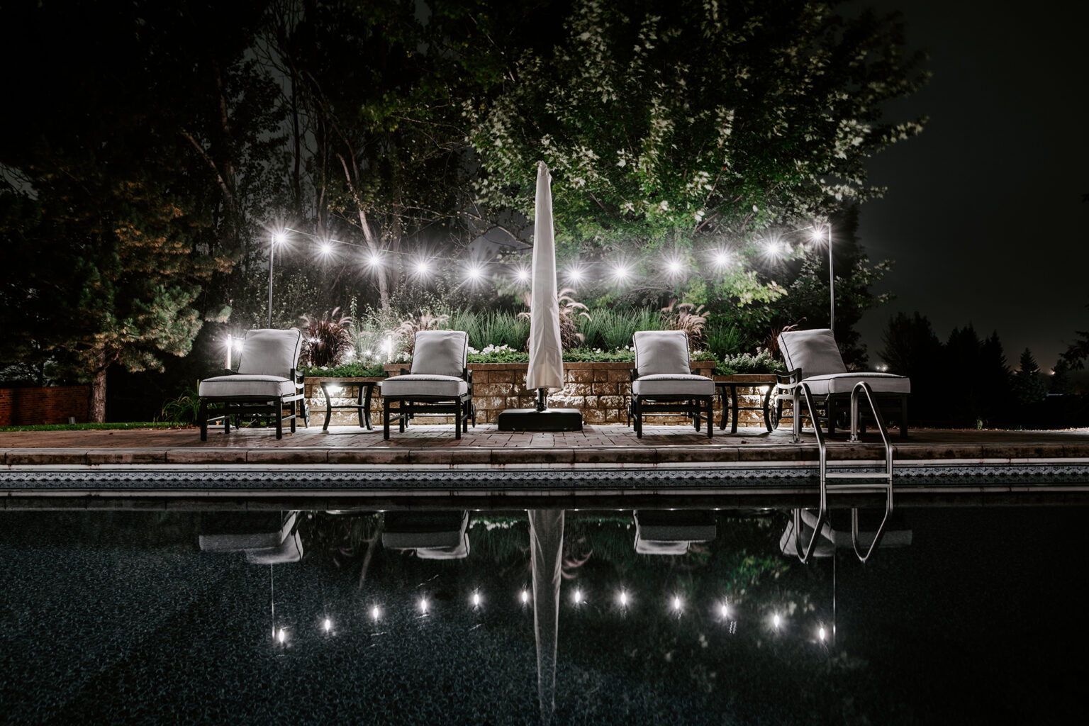 nighttime lights over backyard pool