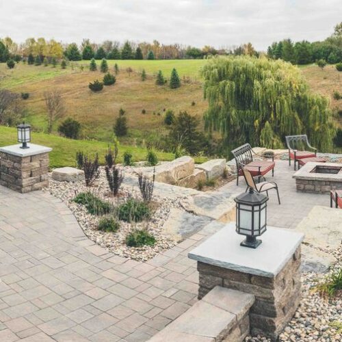 backyard patio with pavers and concrete pillars