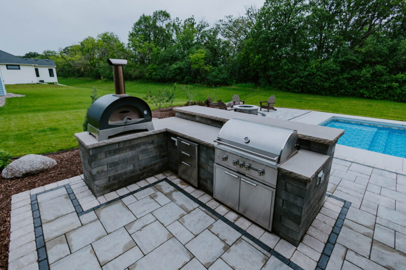 Outdoor kitchen near pool, Weller Brothers Landscaping