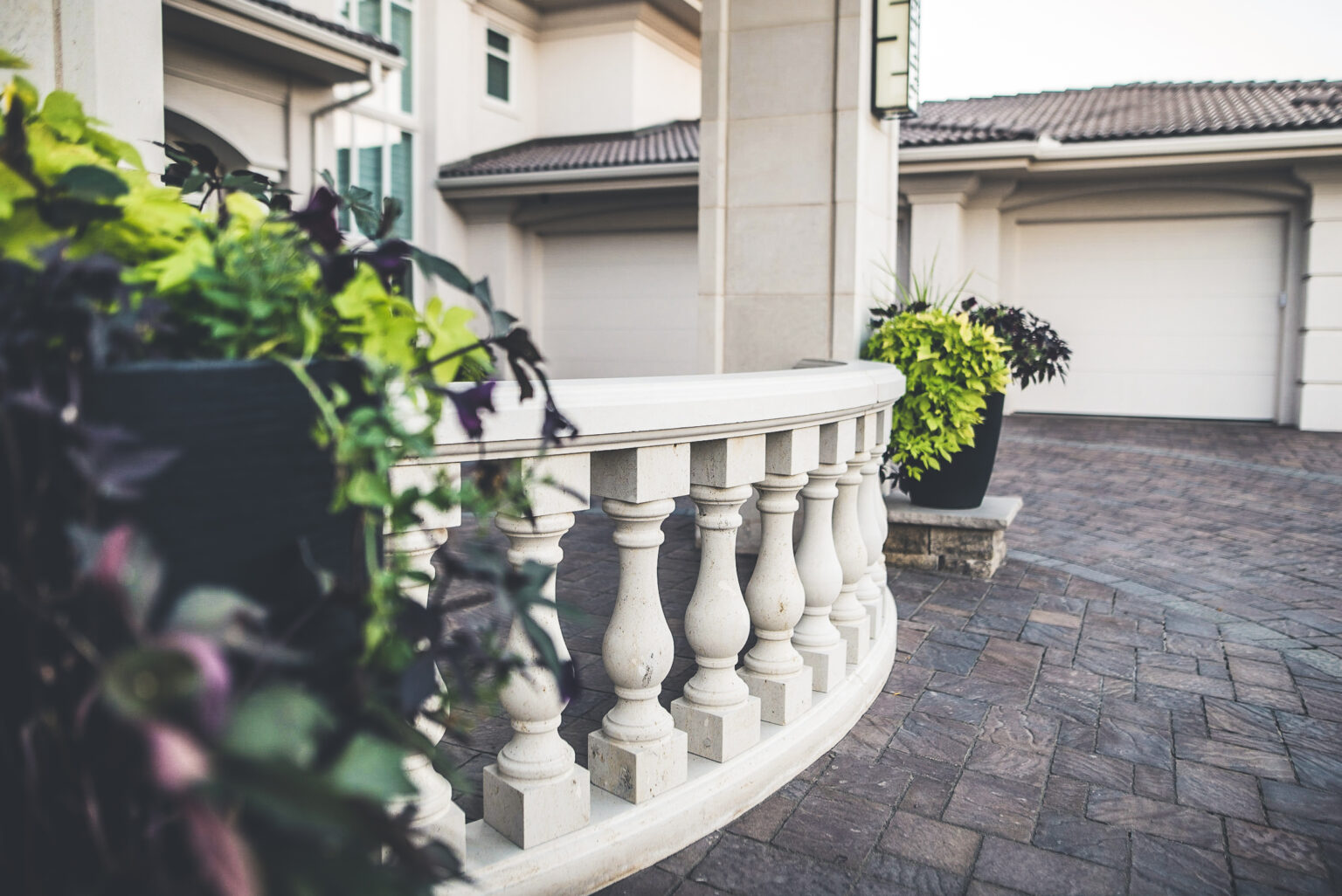 front door portico detail with paver driveway