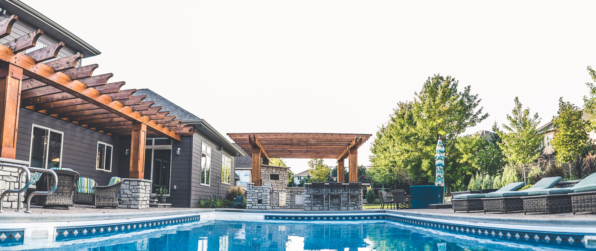 backyard pool and outdoor kitchen by Weller Brothers Landscaping
