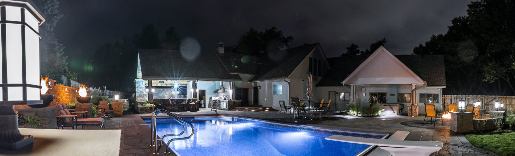 custom pool and paver patio at night