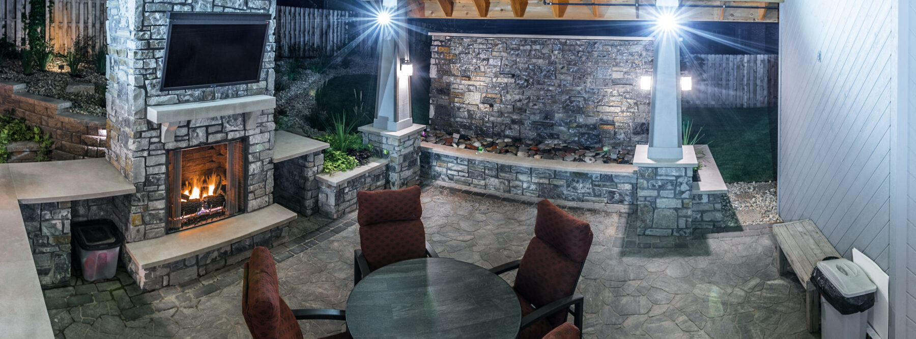 custom outdoor fireplace at night