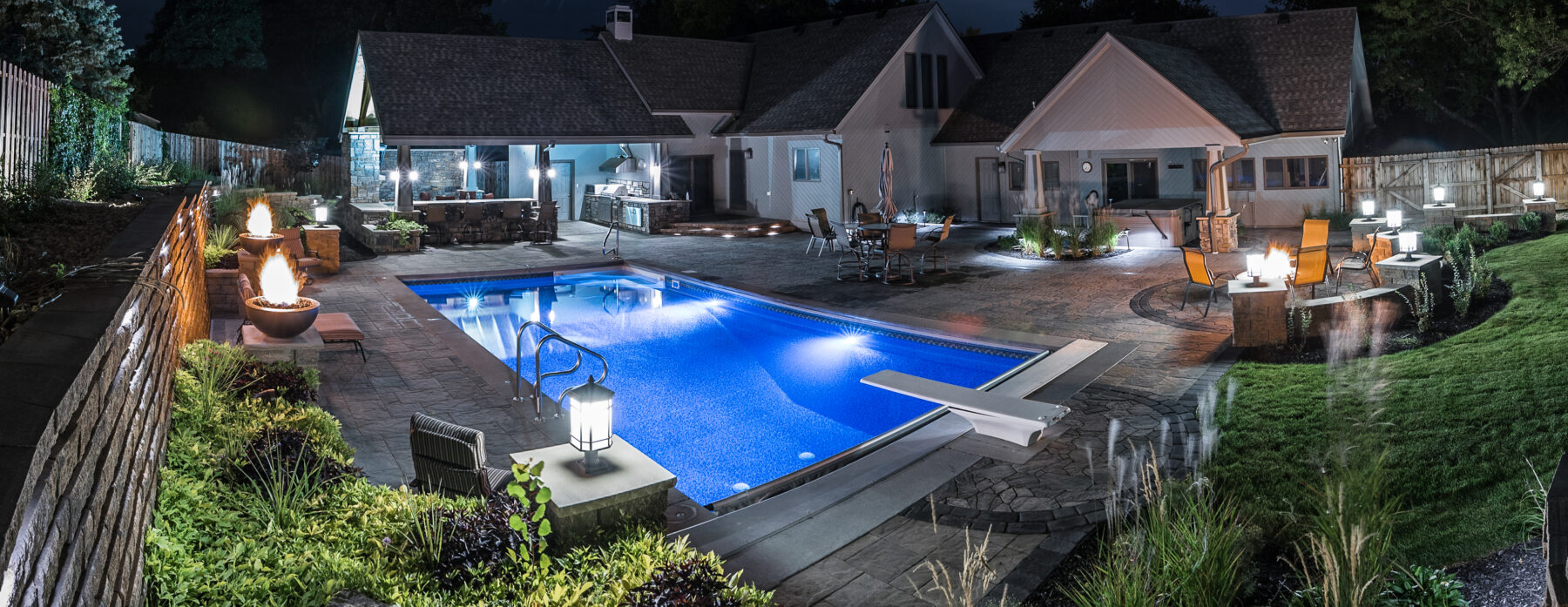 pool landscaping with diving board at night