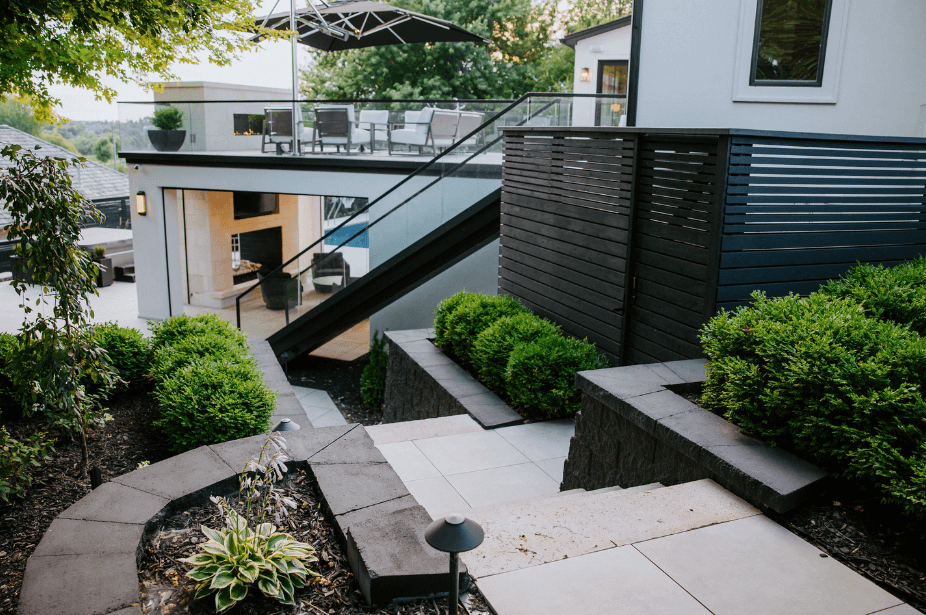 backyard staircase look down onto patio and firepit