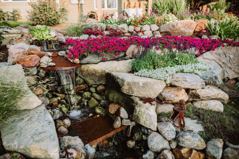 backyard water feature with flower bed