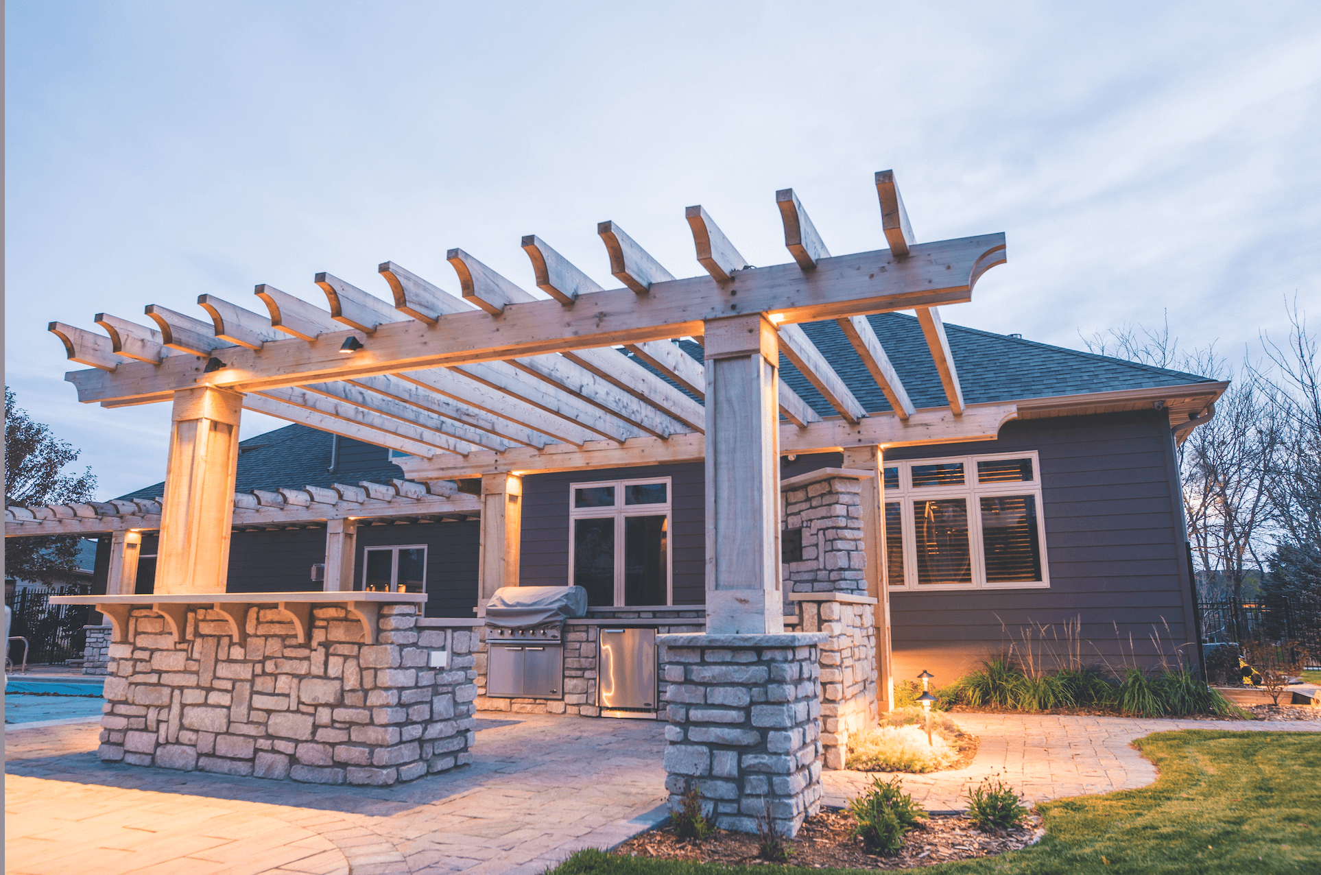 Backyard pergola with landscape lighting