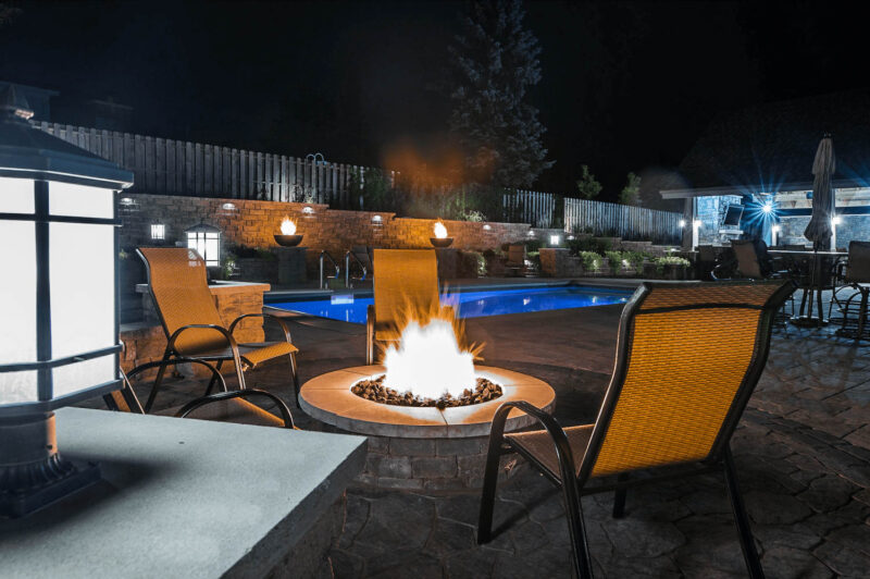 Paito with firepit near pool with Landscape Lighting, Weller Brothers Landscaping