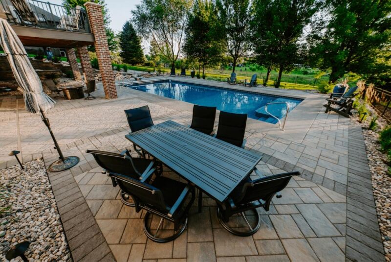 Patio area with dining and a pool, Weller Brothers Landscaping