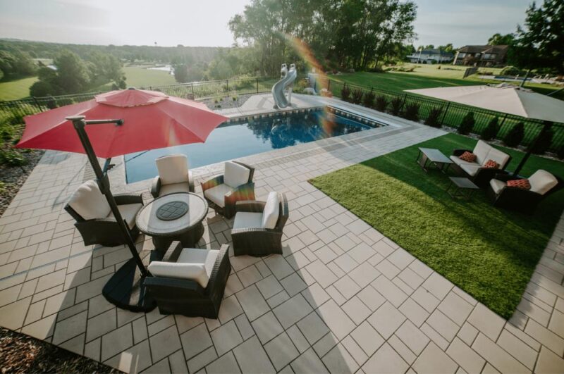 Patio with umbrella with a pool, Weller Brothers Landscaping