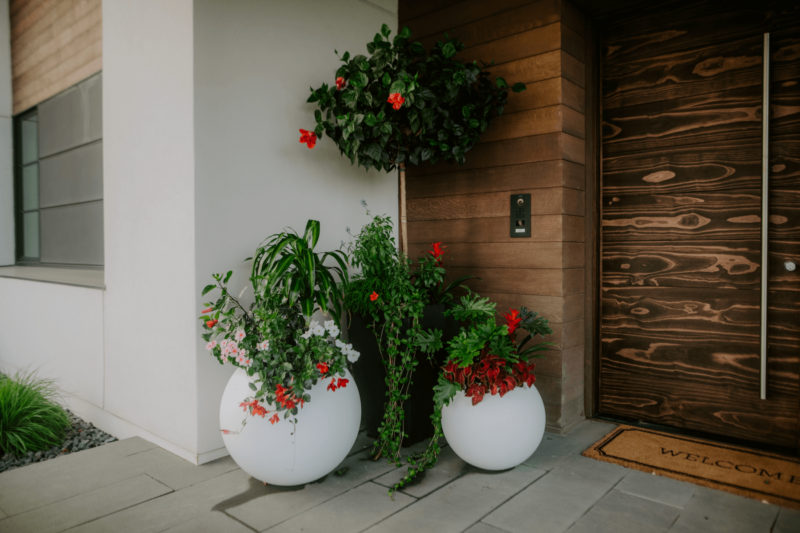 Seasonal flower planters on a customer's porch