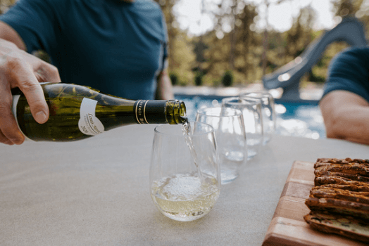 pouring wine at outdoor kitchen