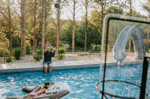 man shooting basketball over pool