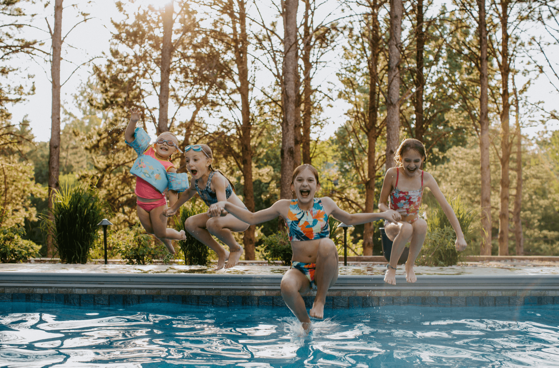 young swimmers jumping into pooll