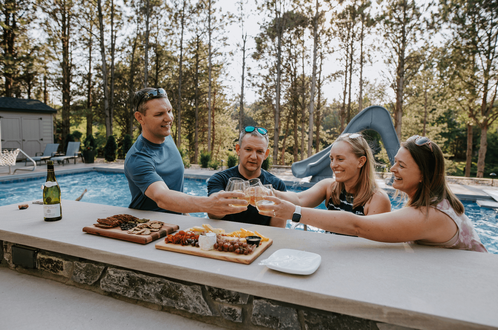 Family enjoying wine in backyard