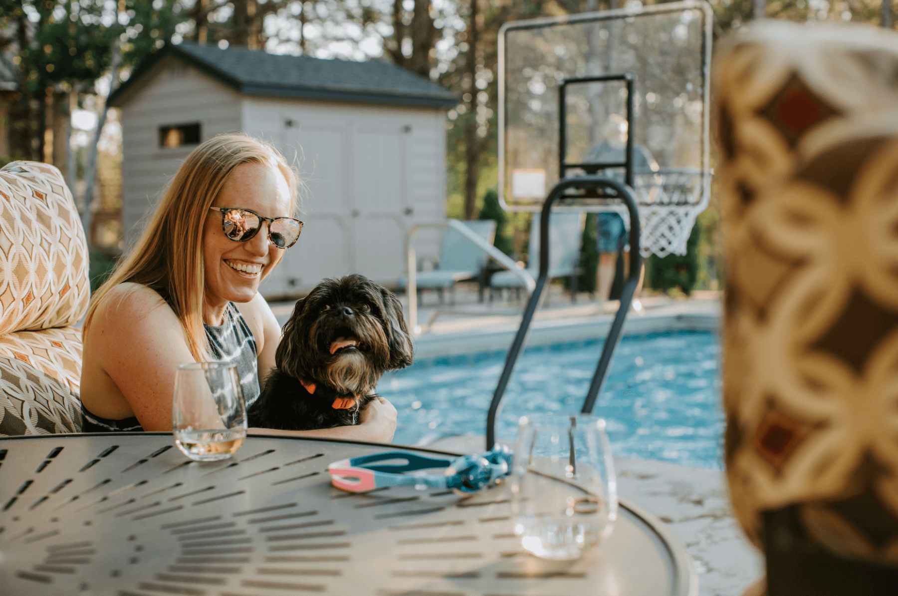 woman and dog by pool