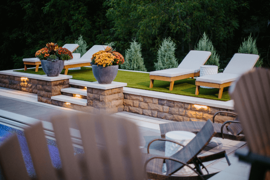 Backyard landscape lighting and loungers