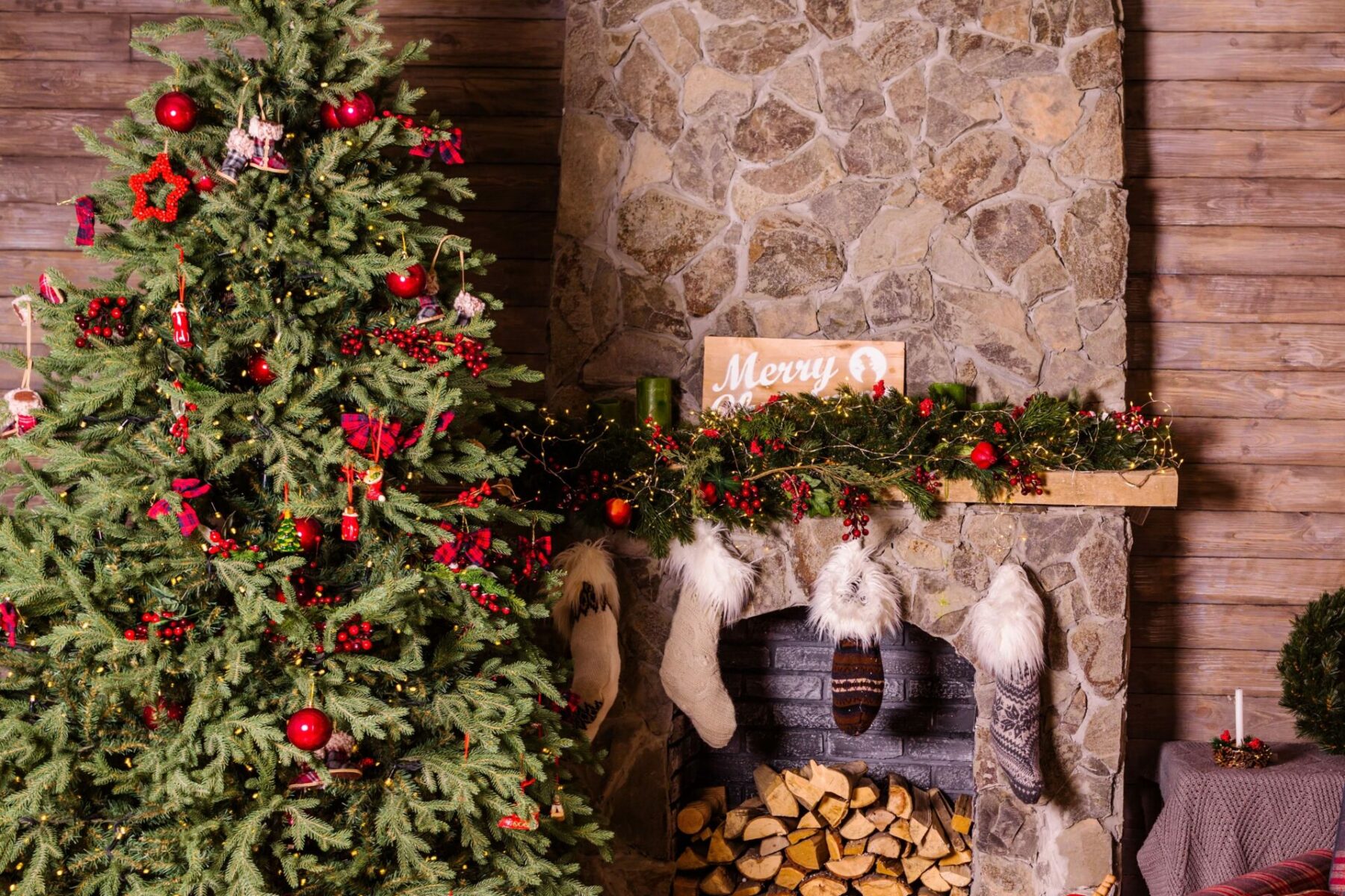 Christmas Tree near Wood Fire Place with Stockings Being Hung