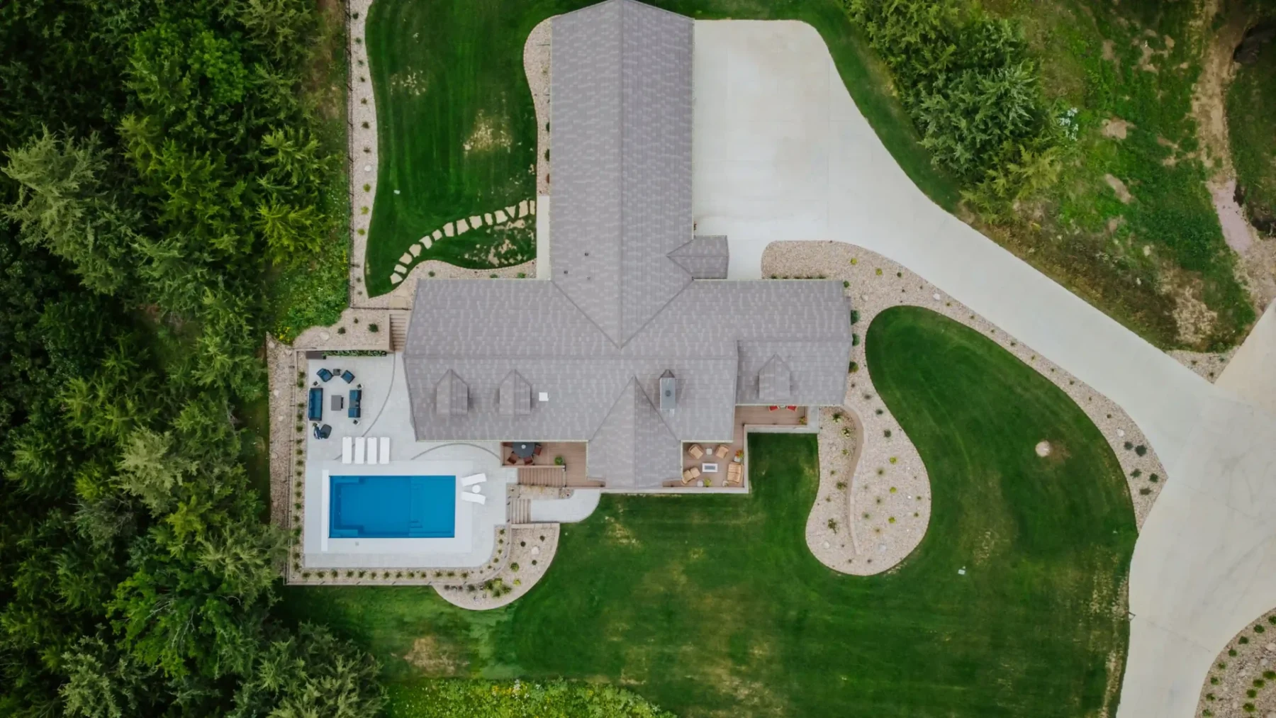 an aerial view of a newly built home with outdoor landscaping