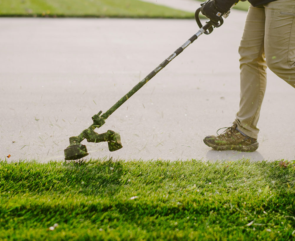 Weller Brothers member trimming lawn